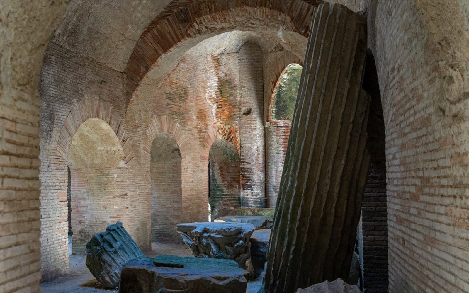 The brick underground galleries beneath the Flavian Amphitheater at Pozzuoli, where stage machinery once lifted animals into the arena